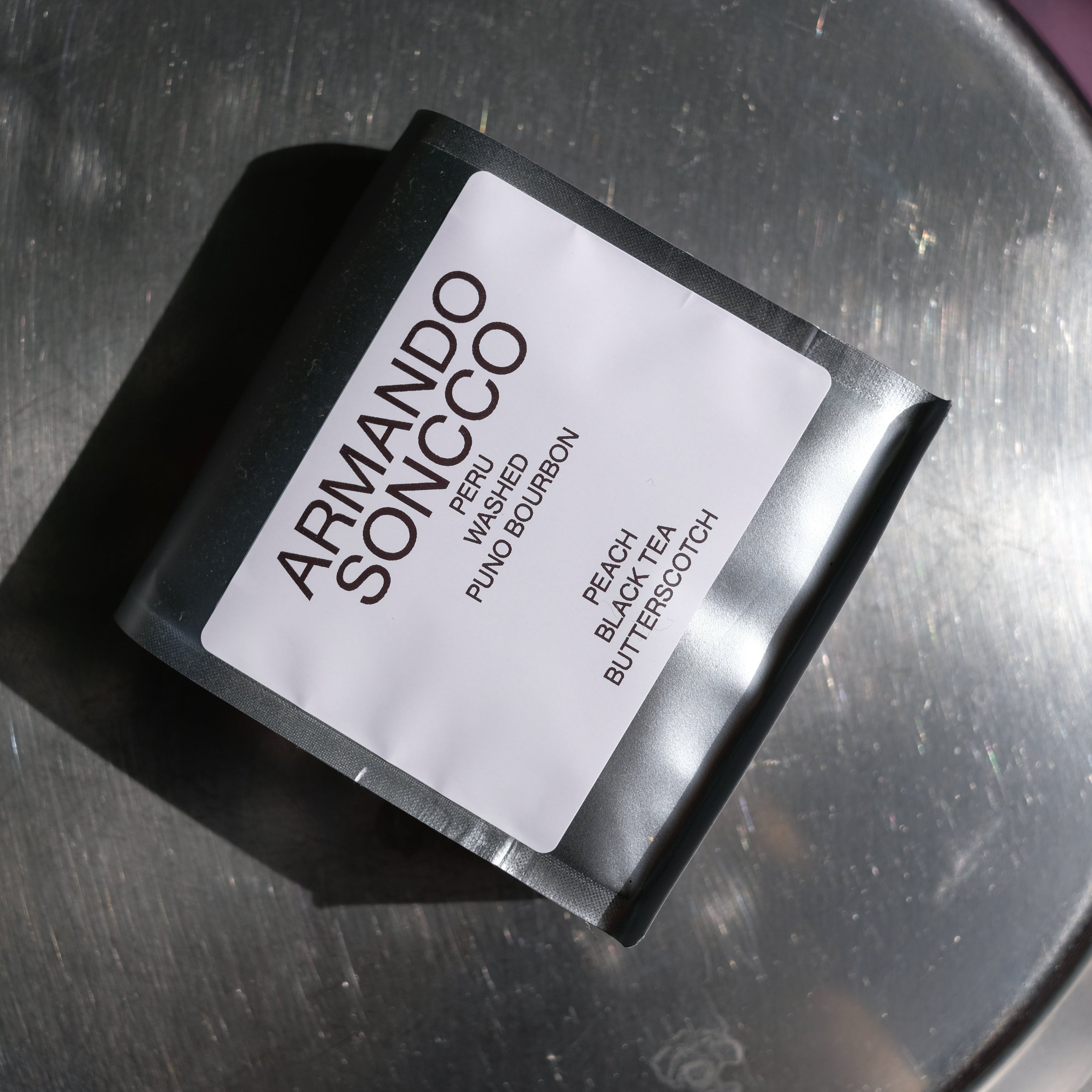 A bag of Armando Soncco on a metallic surface.